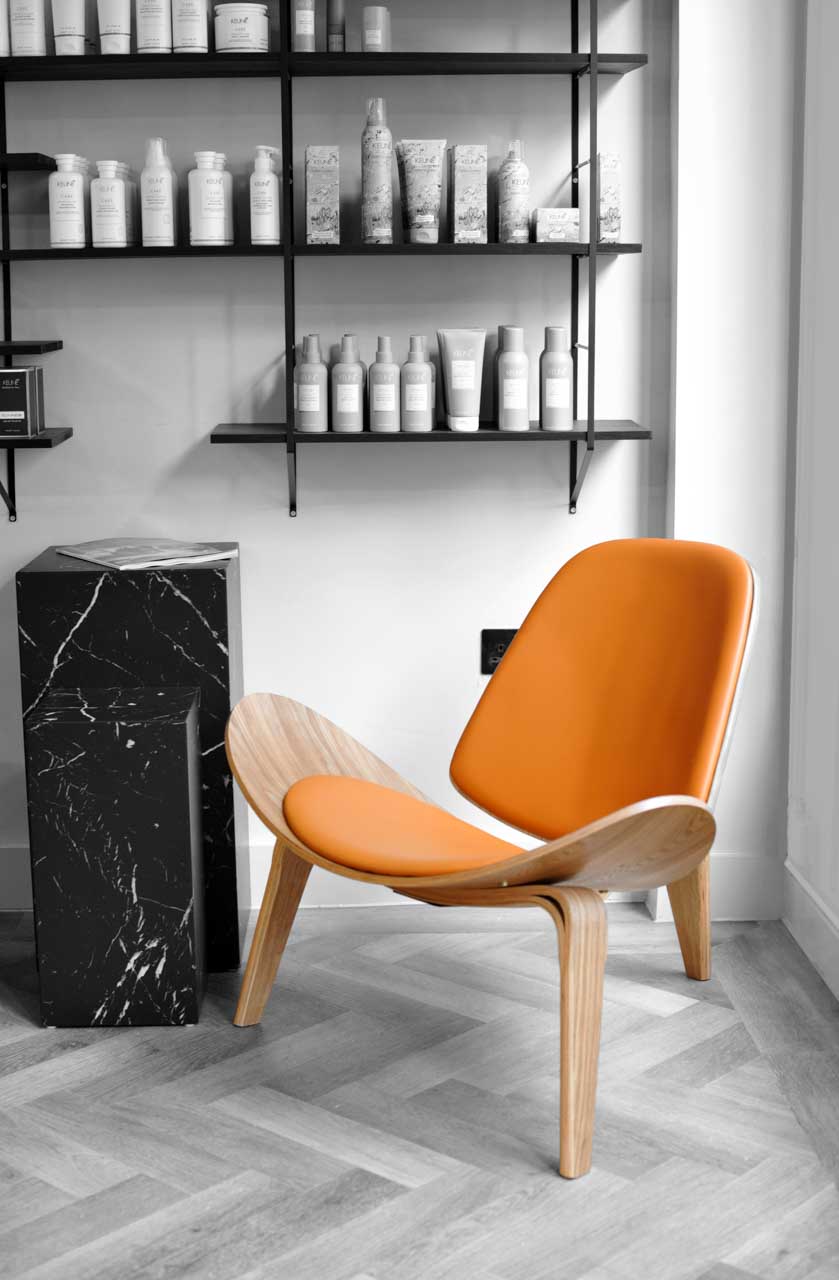 Inside Kristina B salon shelves and orange chair